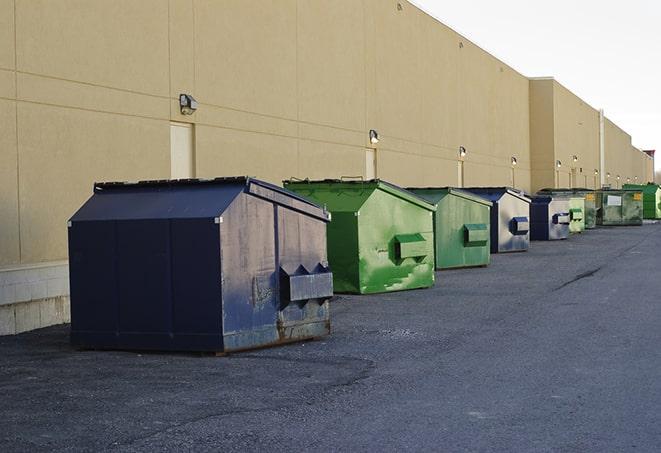 a group of dumpsters lined up along the street ready for use in a large-scale construction project in Grants Pass